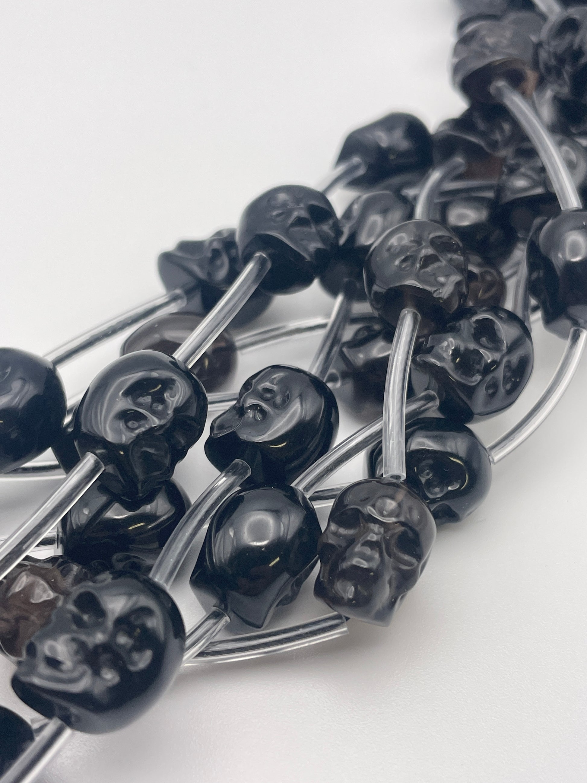 10mm Obsidian Vertical Drilled Skull Bead Strand.