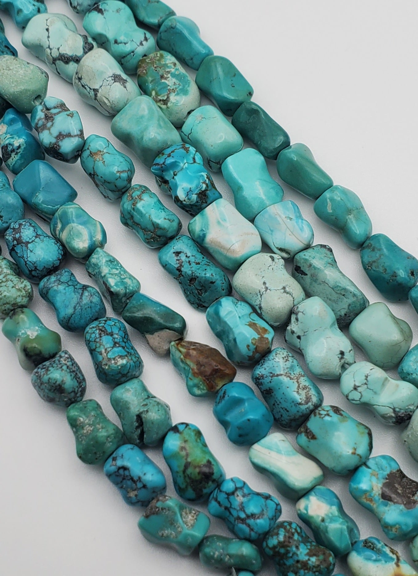 10mm Turquoise Dog Bone Shaped Bead Strand.