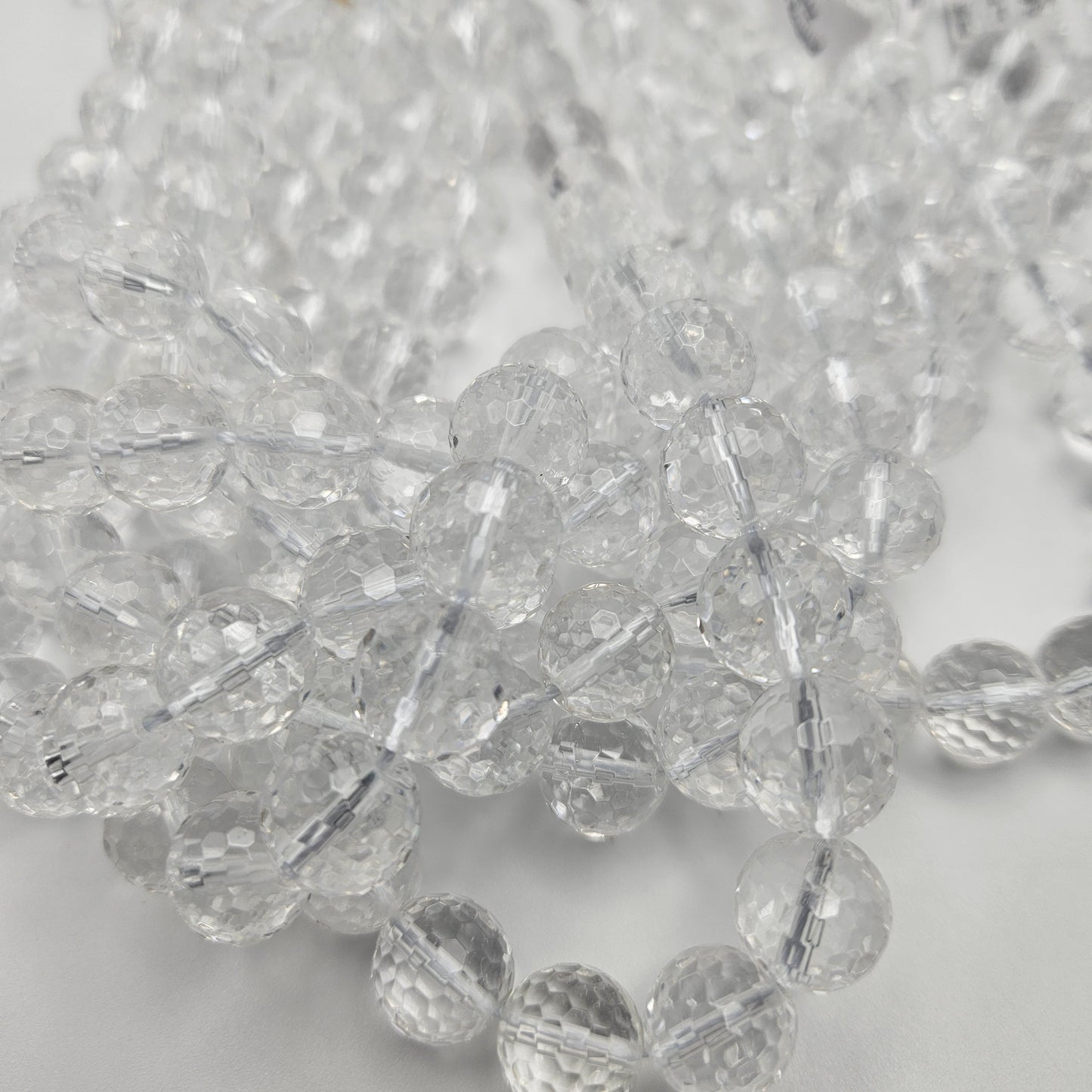 12mm Clear Quartz Faceted Round Bead Strand.