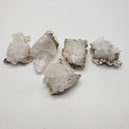 Five rough, translucent white Druizy Quartz Pendant crystals with metallic edges are arranged on a white surface.