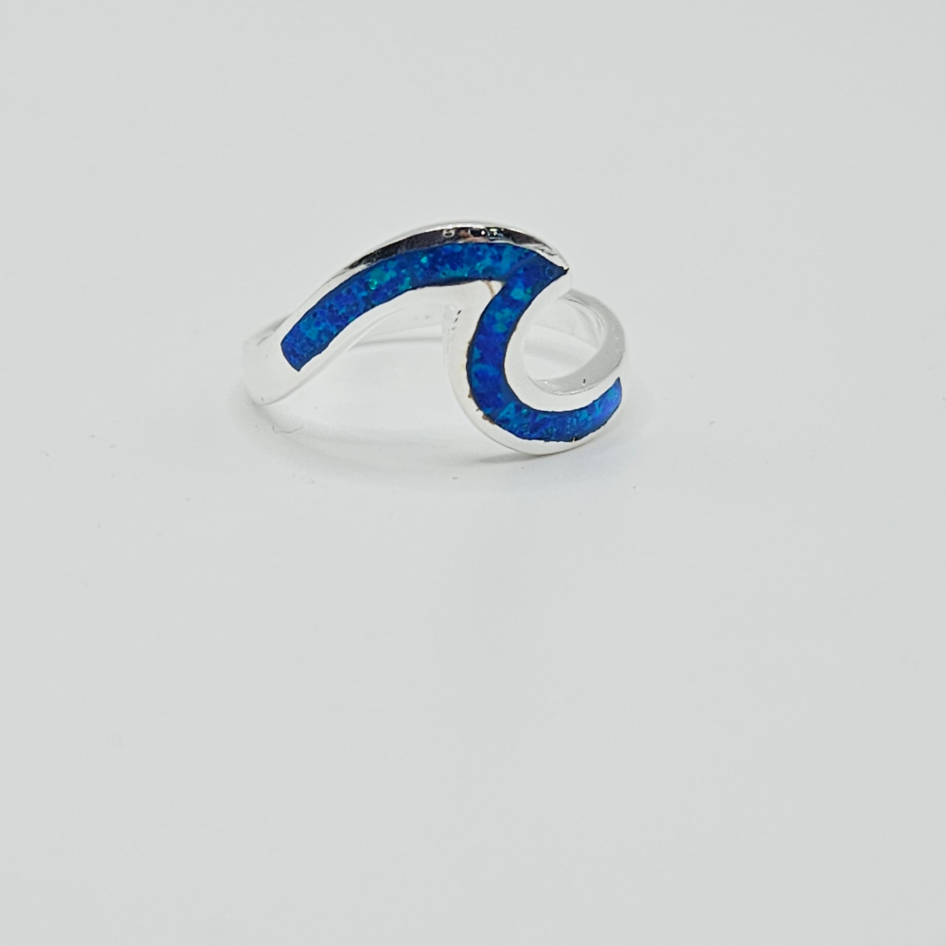 A silver-colored open band ring with blue and turquoise