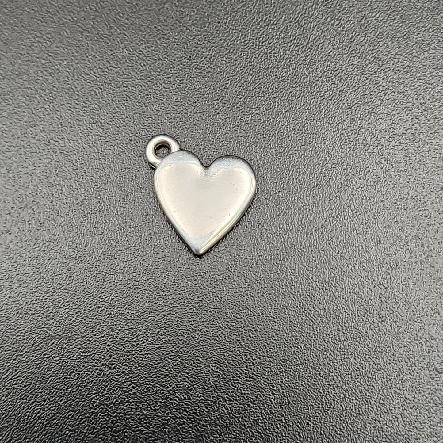 A silver-plated heart-shaped charm for jewelry making