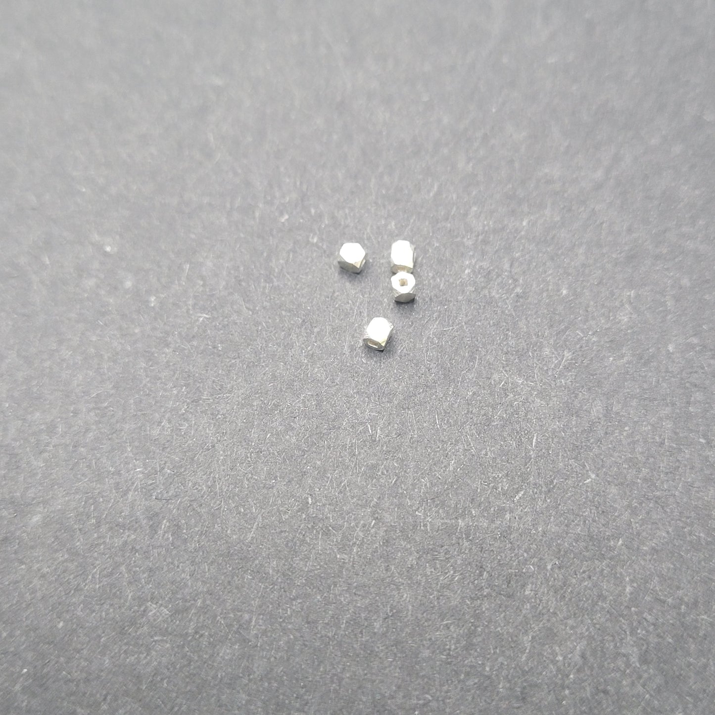 Small metallic objects on a gray surface