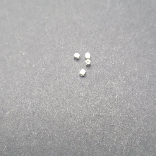 Small metallic objects on a gray surface
