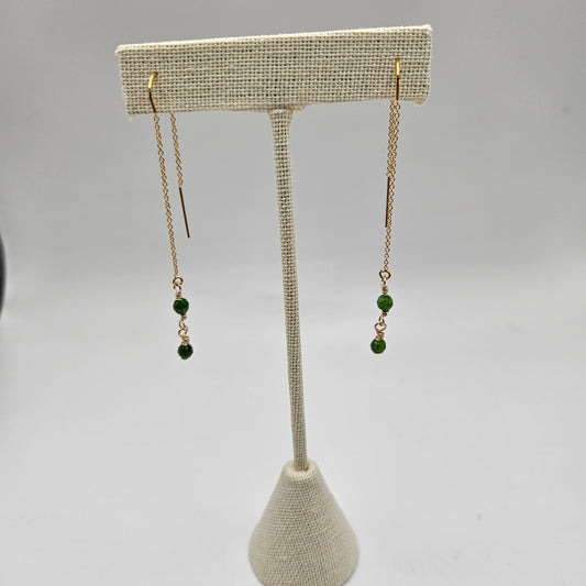 Gold-filled earrings with a geometric pattern, featuring a central diopside stone and smaller clear crystals,
