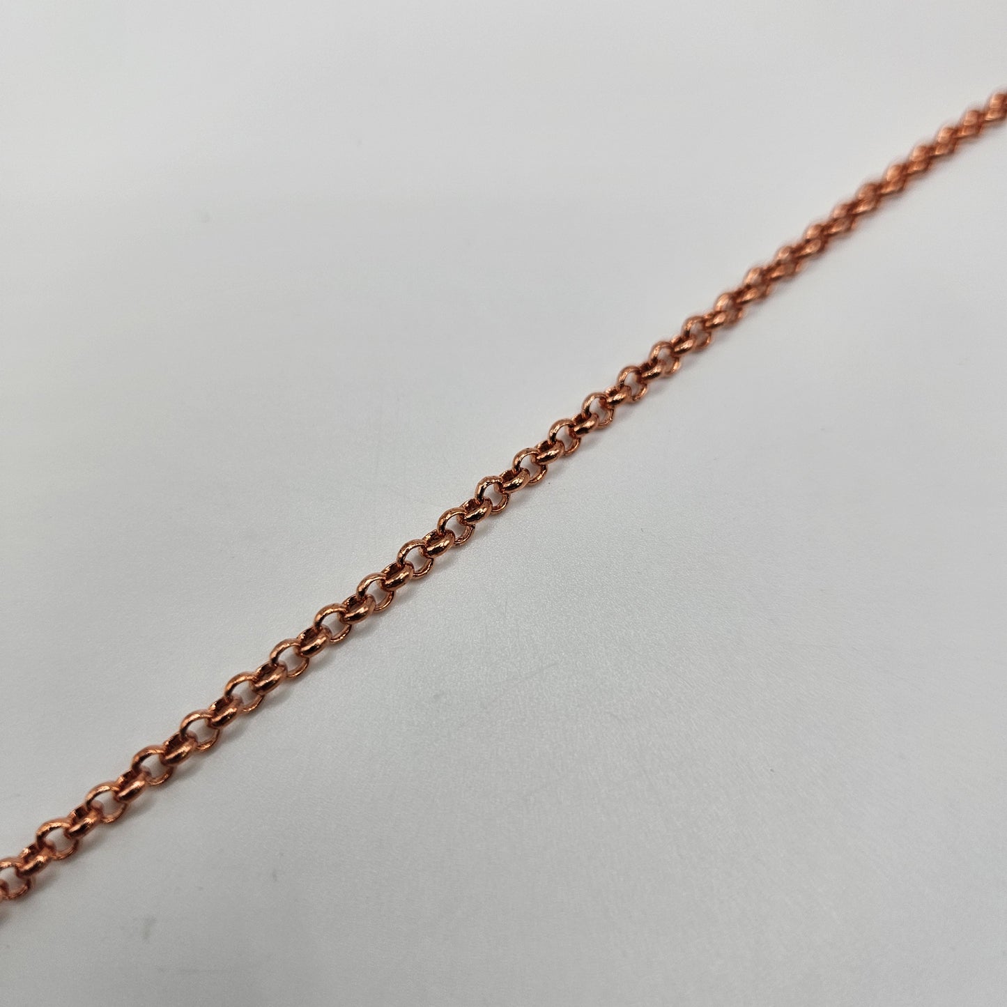 A close-up image of a copper 3mm rolo chain