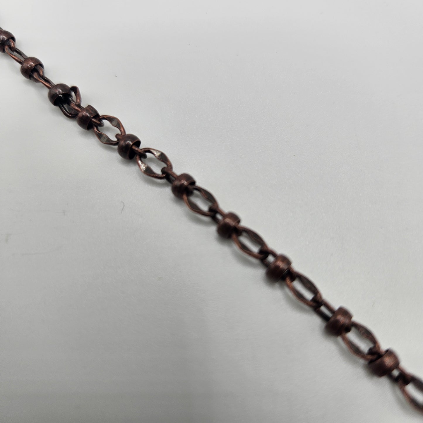 A foot-long copper chain, likely used for jewelry making or craft purposes.