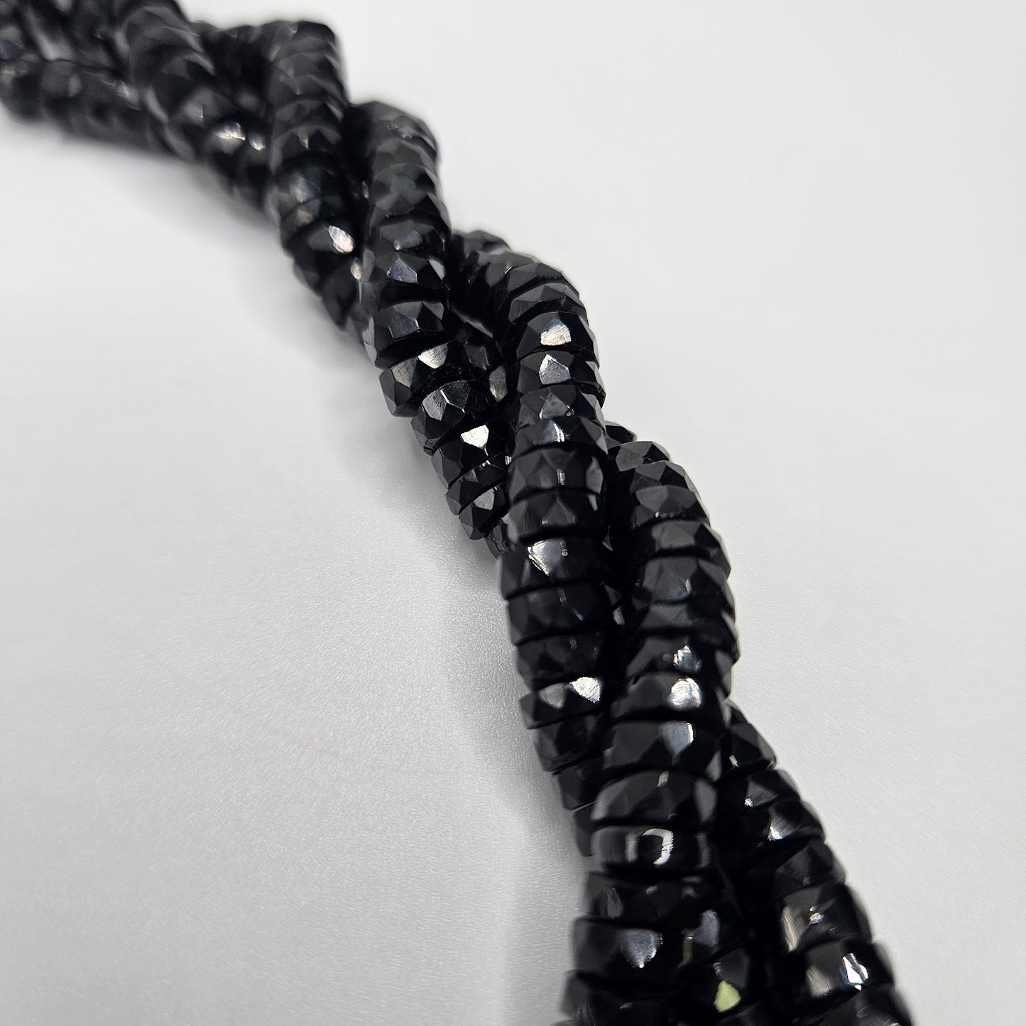 6mm Black Spinel Faceted Coin Strand.