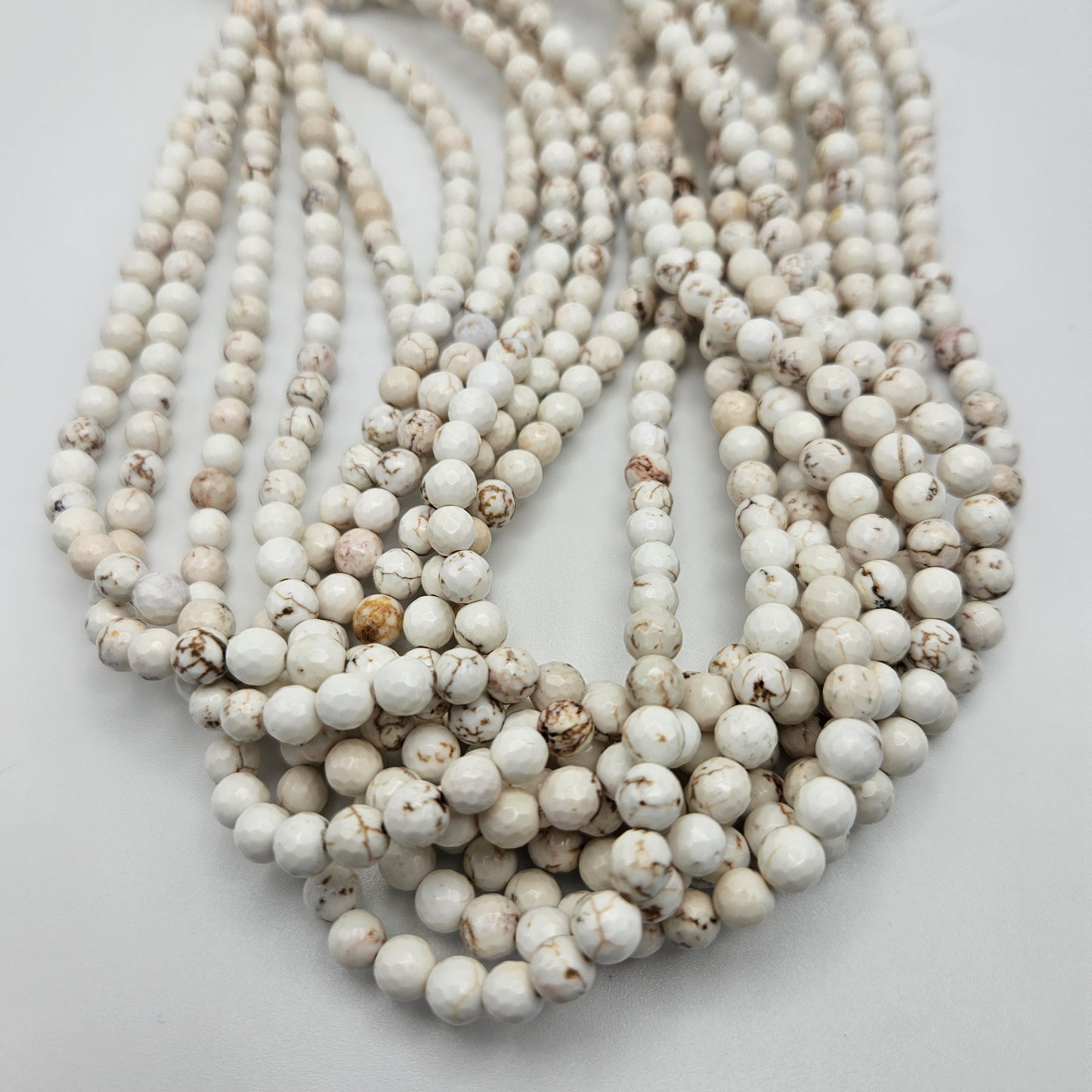 6mm White Buffalo Faceted Round Bead Strand.