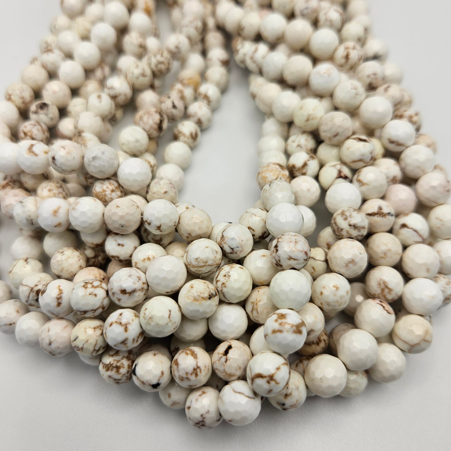8mm White Buffalo Round Faceted Bead Strand.