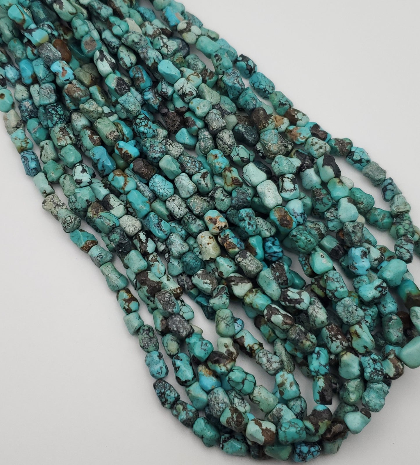 8x10mm Turquoise Dog Bone Bead Strand.