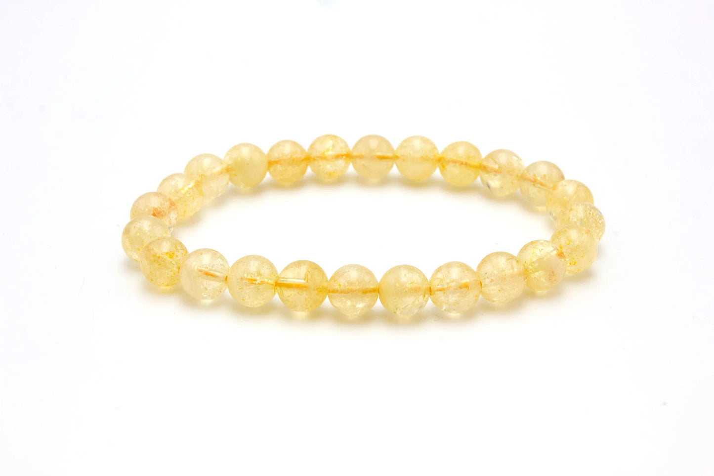 The 8mm Citrine Bracelet, crafted from round, translucent yellow citrine crystals arranged in a circular design, is featured against a white background.