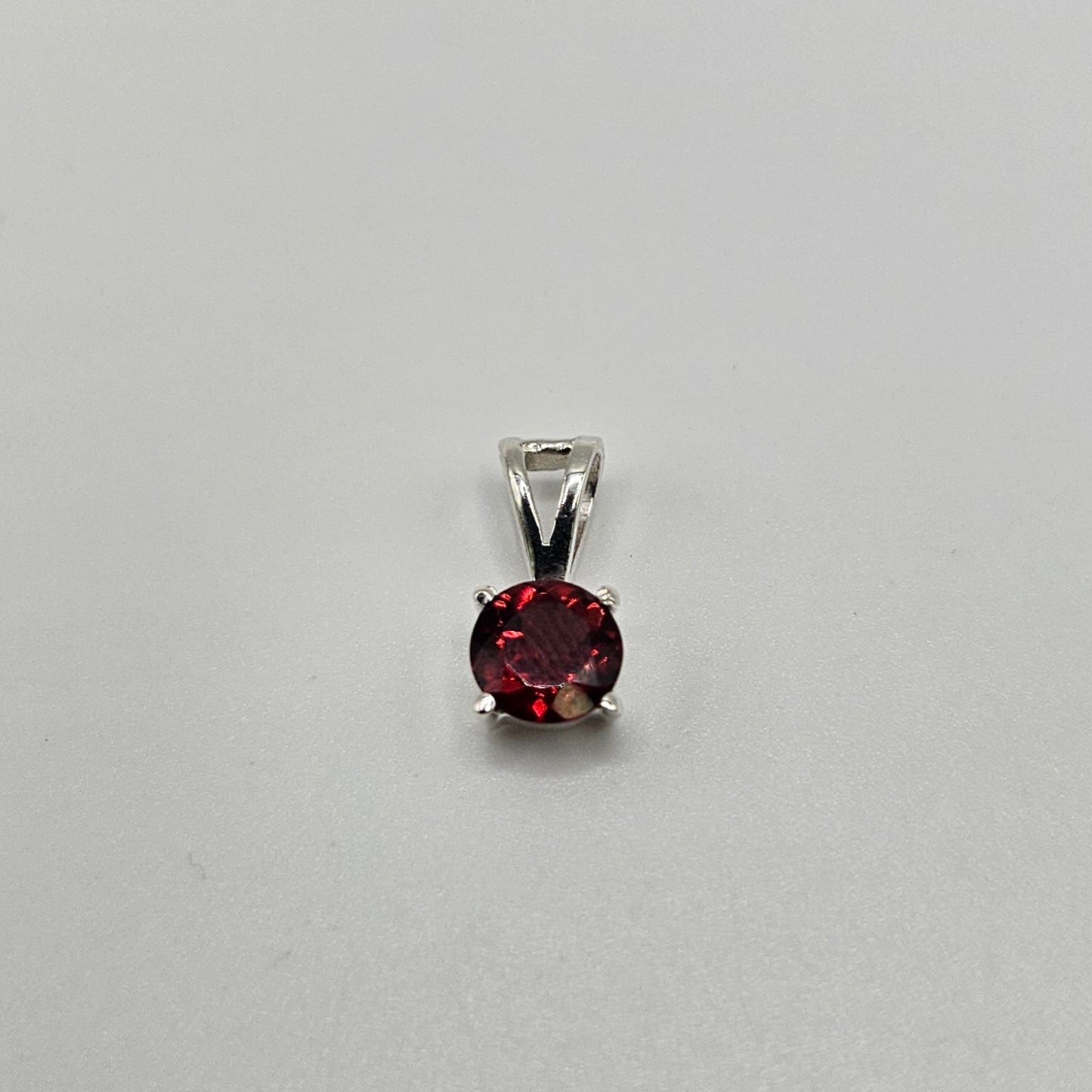 Garnet Sterling Silver Round Faceted Pendant.