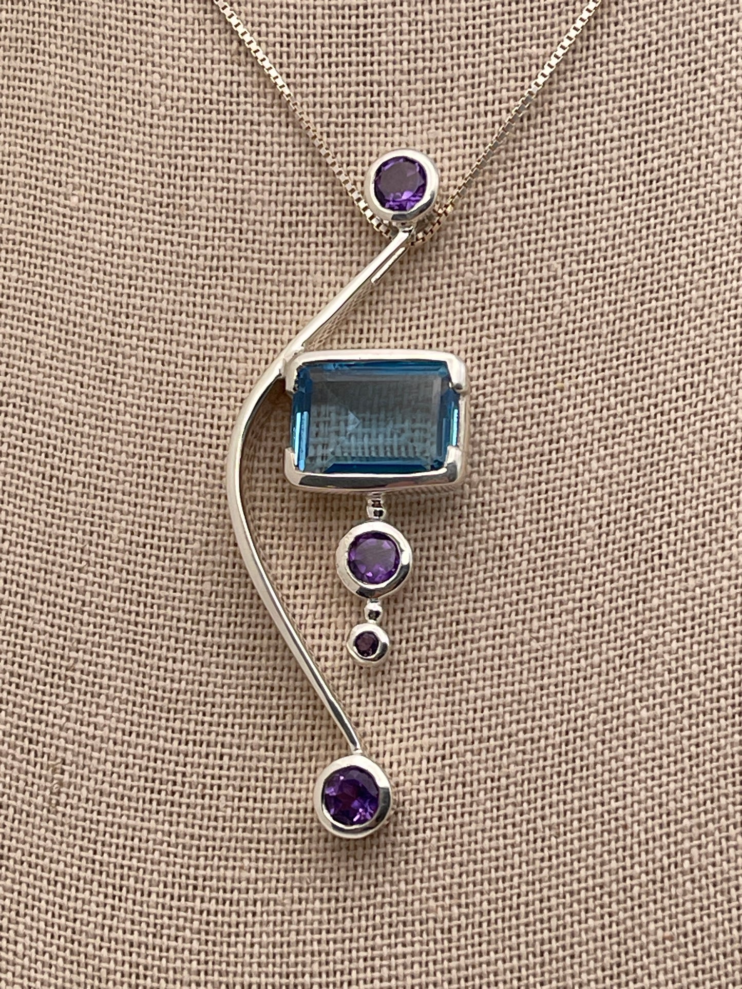 Blue Topaz Rectangle Cut on Solid Bow adorned with Amethyst Sterling Silver Pendant