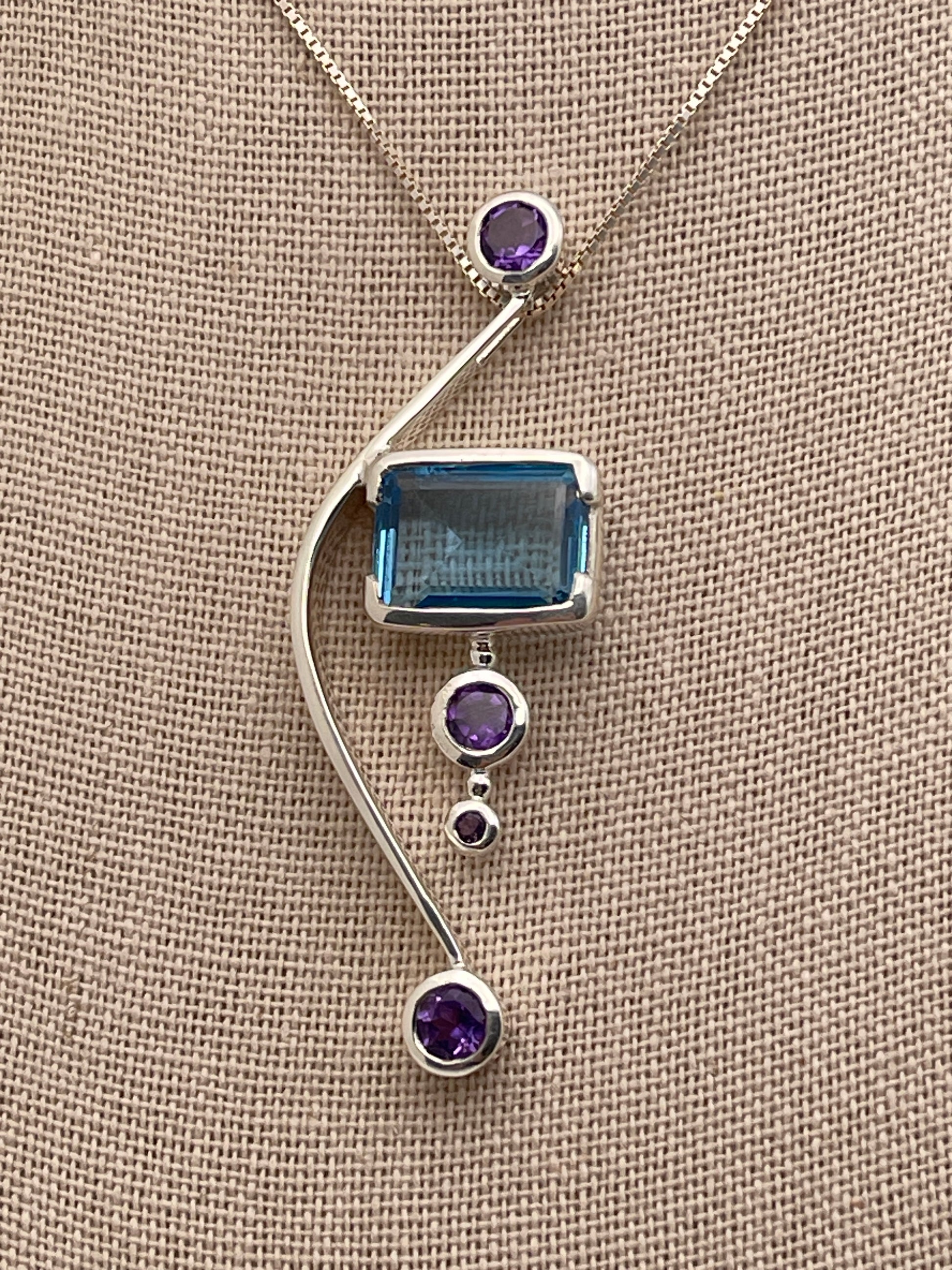 Blue Topaz Rectangle Cut on Solid Bow adorned with Amethyst Sterling Silver Pendant