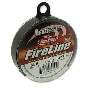 A spool of Berkley FireLine thread for beading, identified as 6 LB FIRELINE CRYSTAL .006 IN/.15MM DIA 50 YRD, in a crystal color that might exhibit slight variations. The packaging is round with a dark loop for hanging and includes the BeadSmith logo alongside product details.
