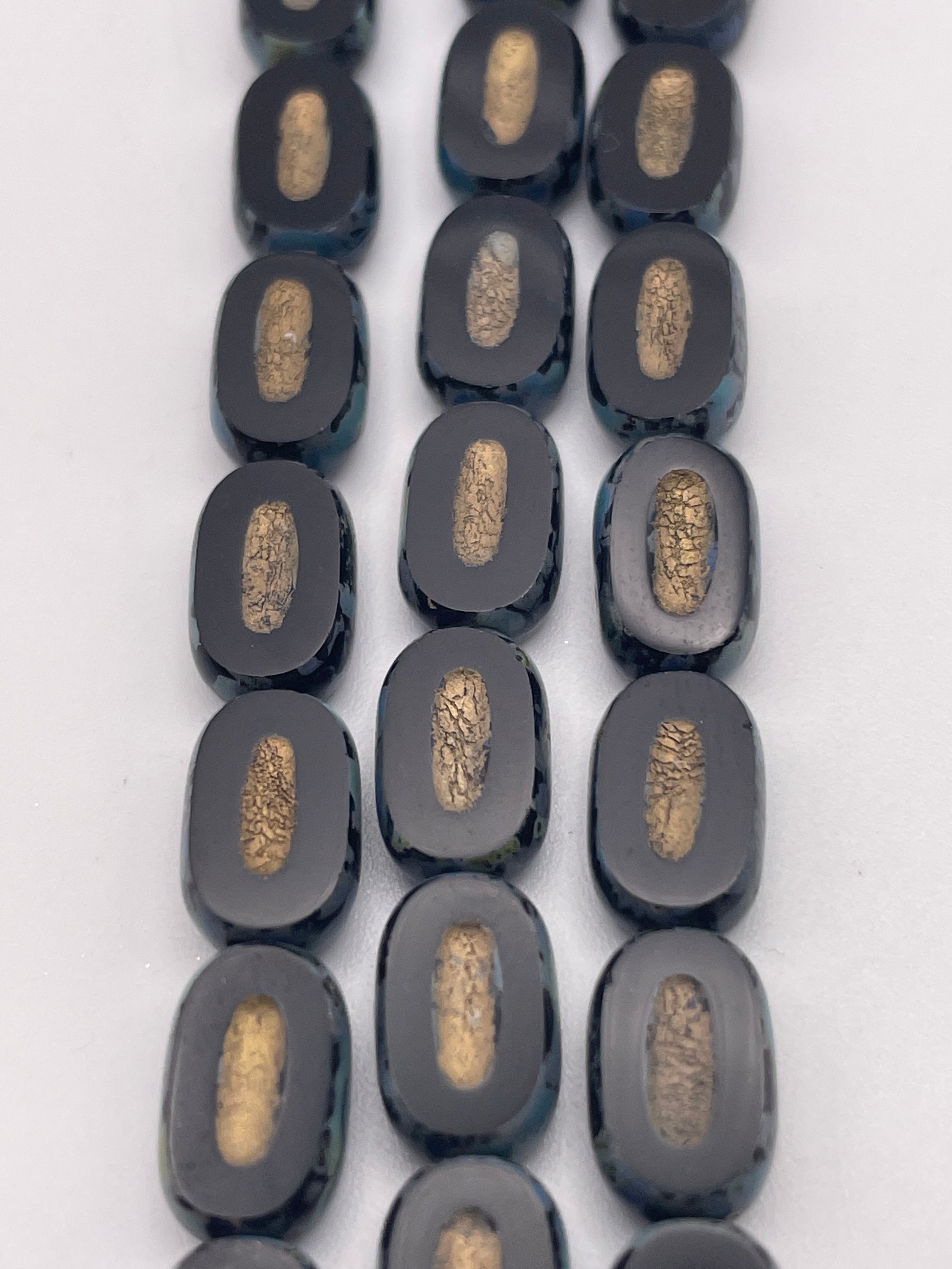 10mm Black Oval Slice With Indent Czech Bead Strand.