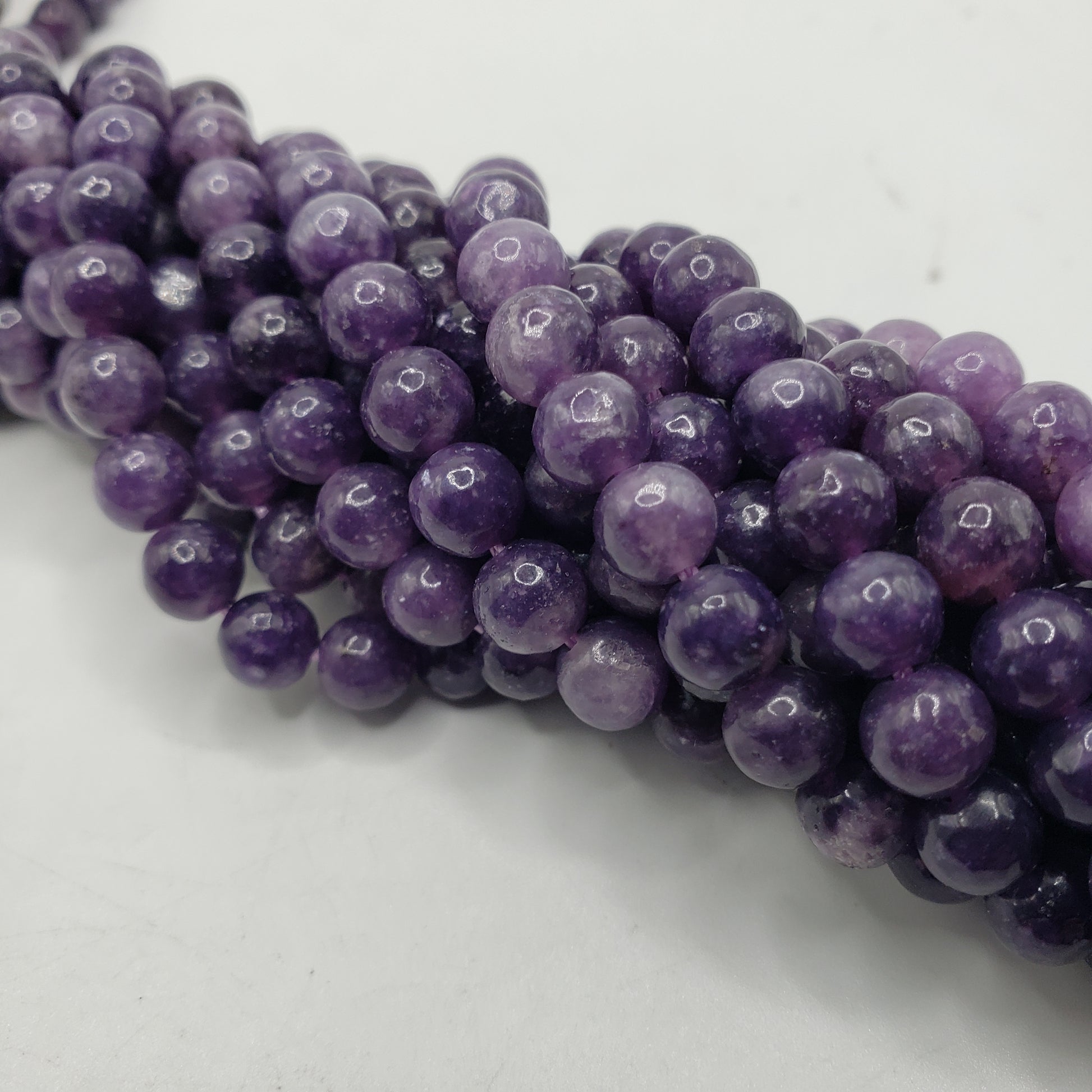 A string of purple lepidolite stones.