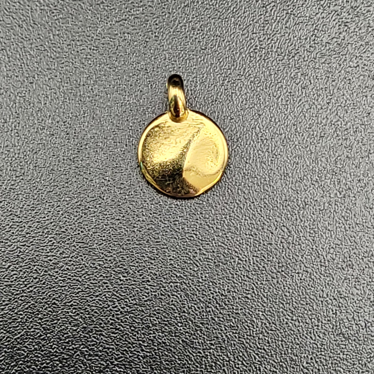 A gold-plated hammered mini disc charm 