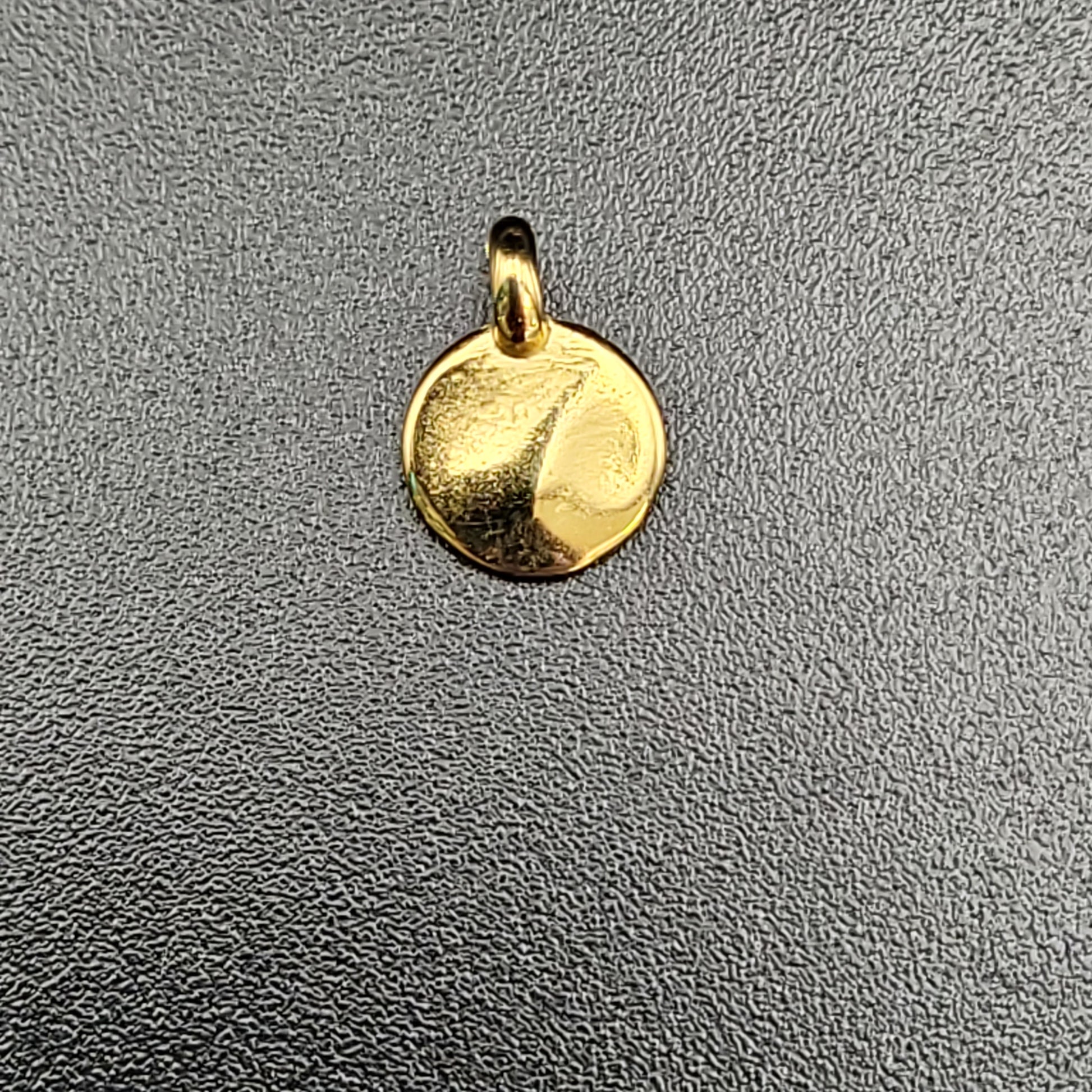 A gold-plated hammered mini disc charm 