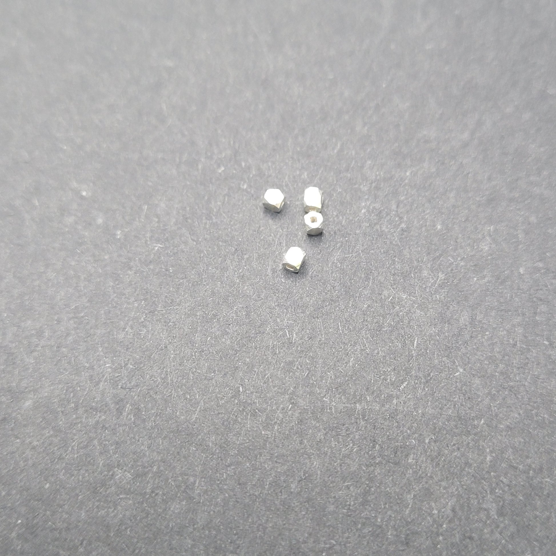 Small metallic objects on a gray surface
