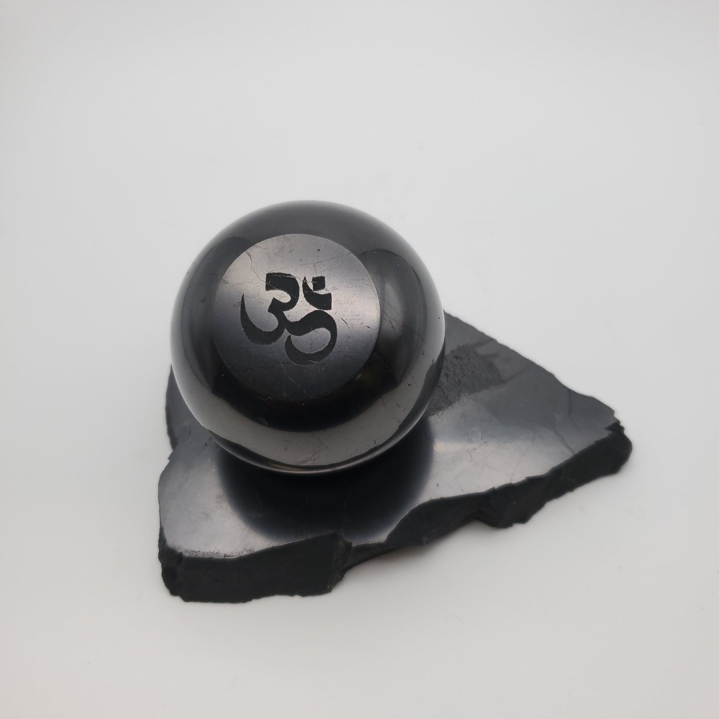 Shungite Sphere Om Engraved with Sphere Stand