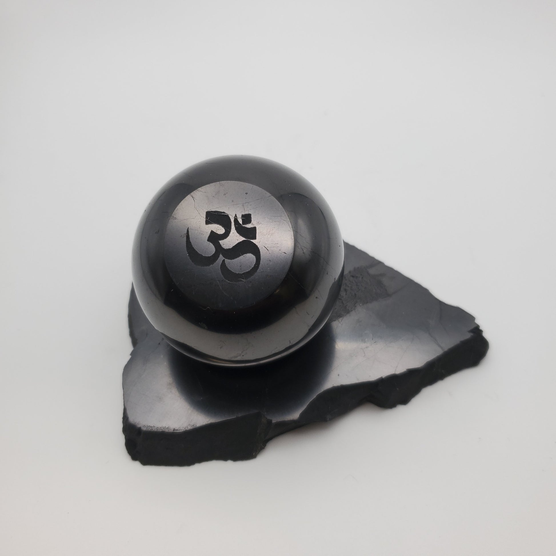 Shungite Sphere Om Engraved with Sphere Stand