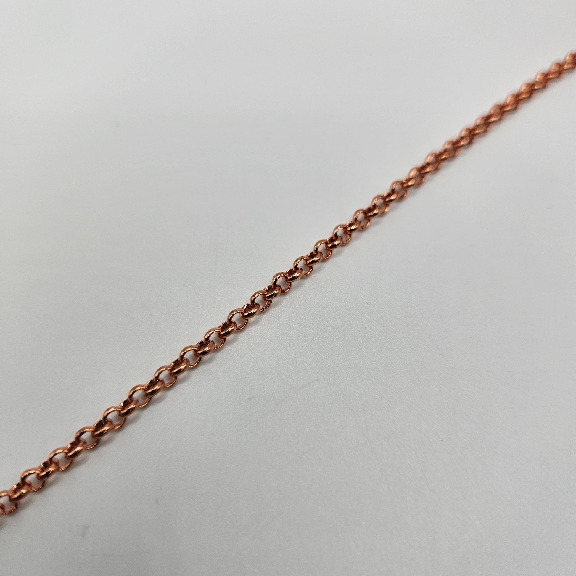 A close-up image of a copper 3mm rolo chain