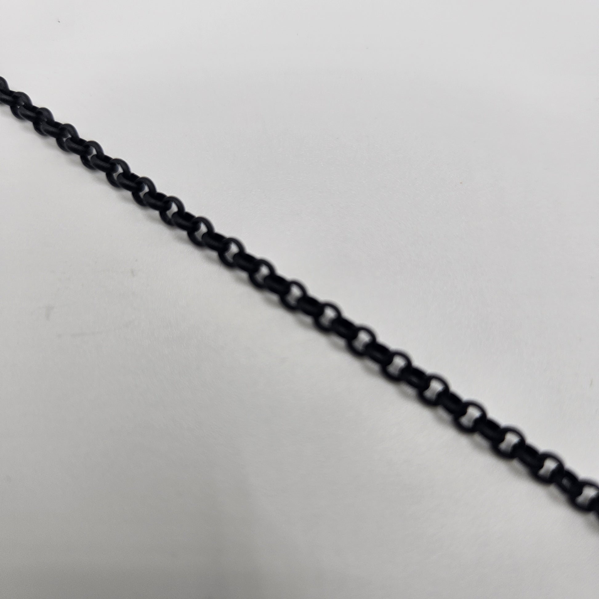 A close-up image of a black 3mm rolo chain
