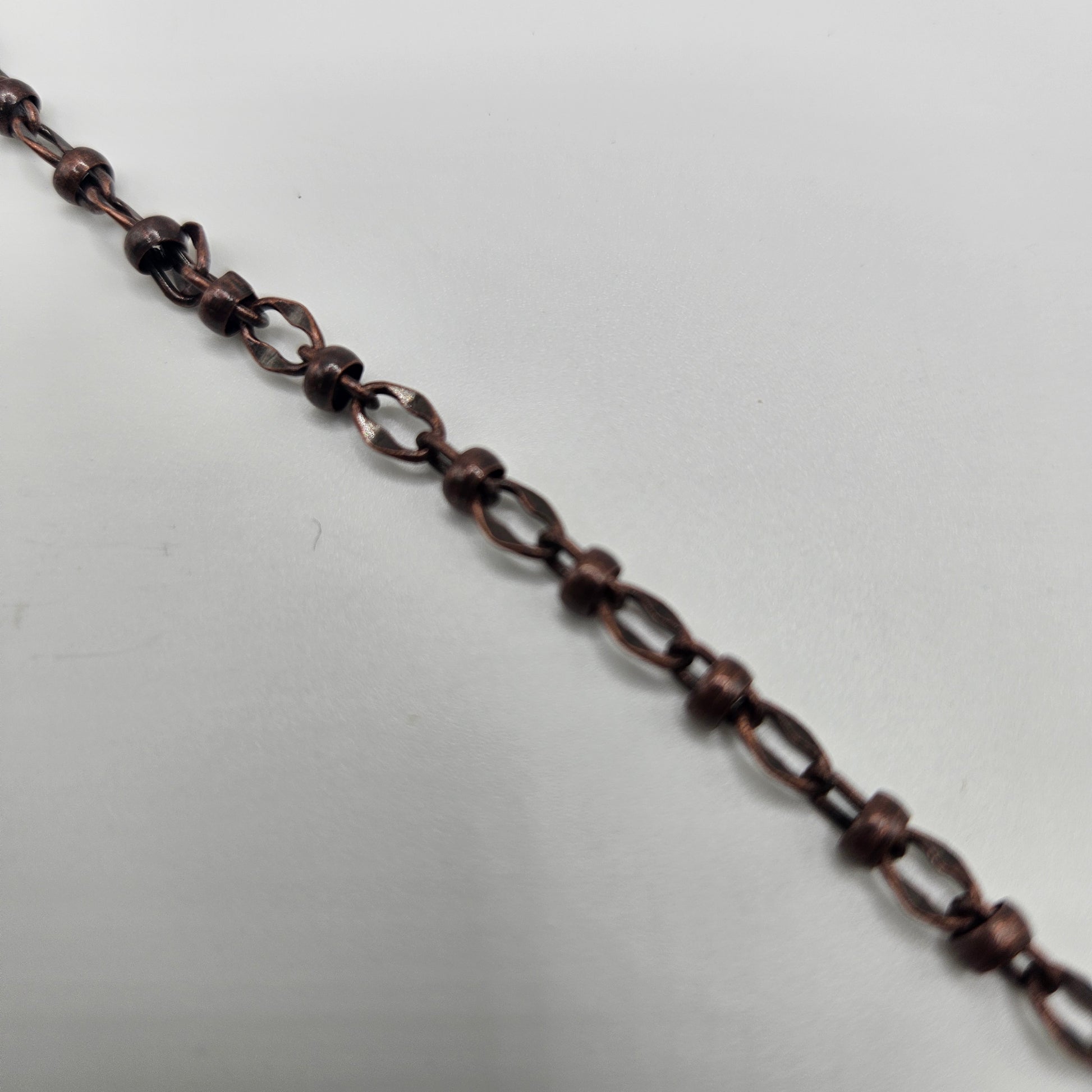 A foot-long copper chain, likely used for jewelry making or craft purposes.