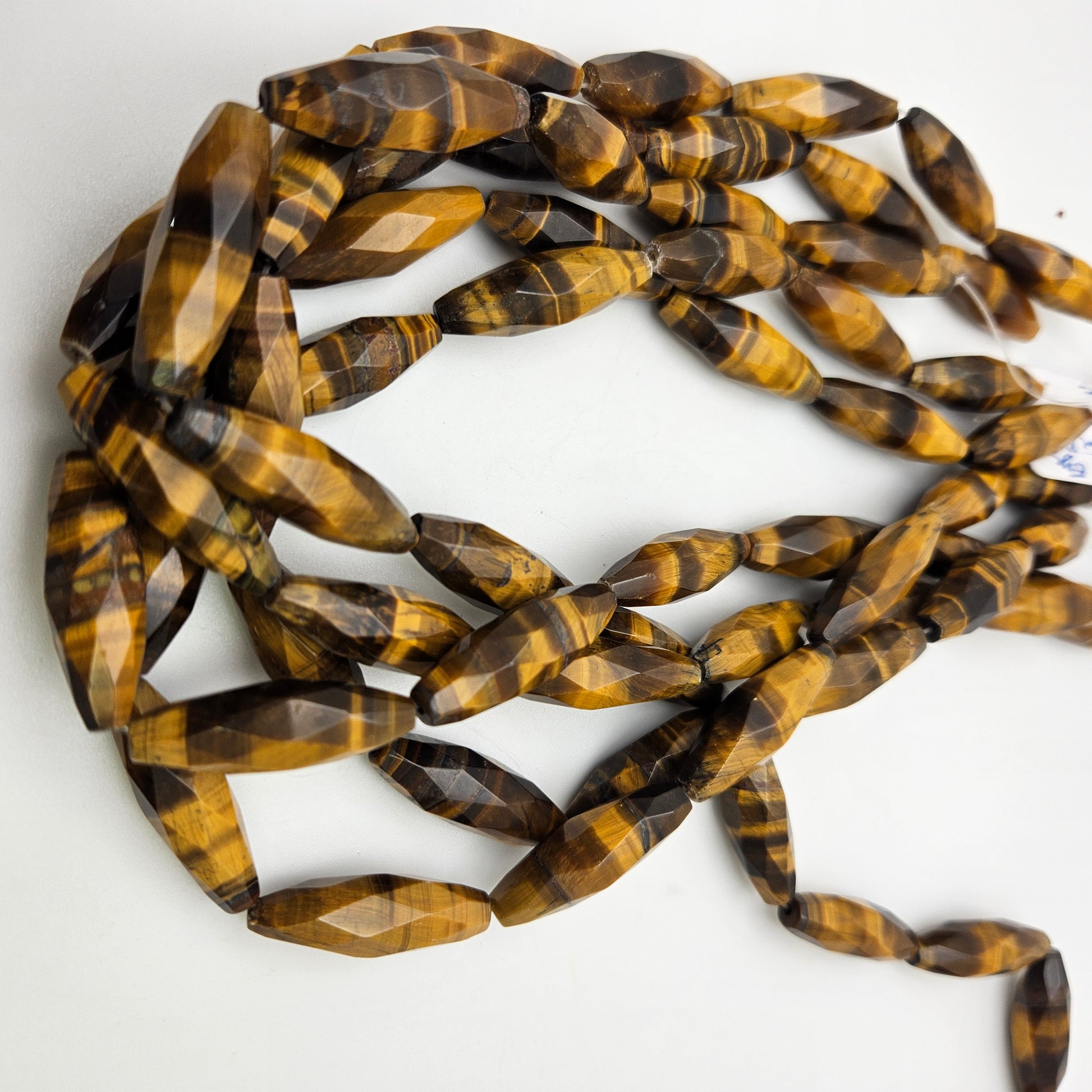 25mm Tiger's Eye Faceted Rice Bead Strand.