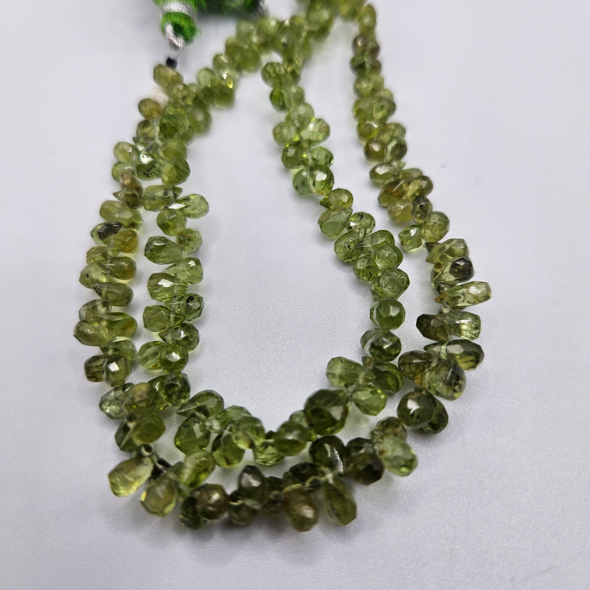 3 by 5mm faceted peridot briolette peridot bead strand.