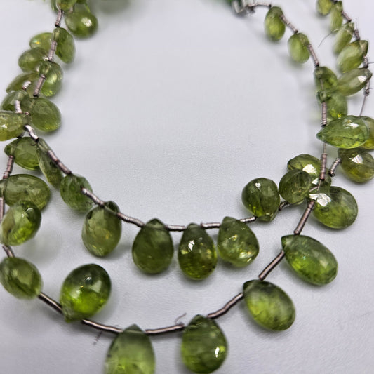 4 by 6mm faceted peridot top drill bead strand.