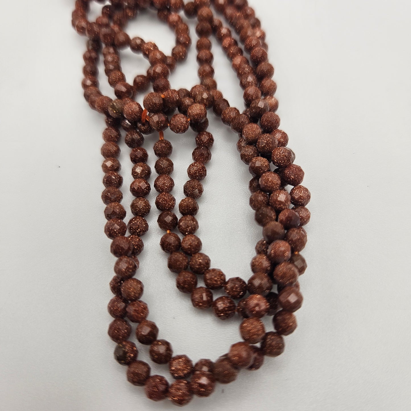 4mm Goldstone Faceted Round Bead Strand.