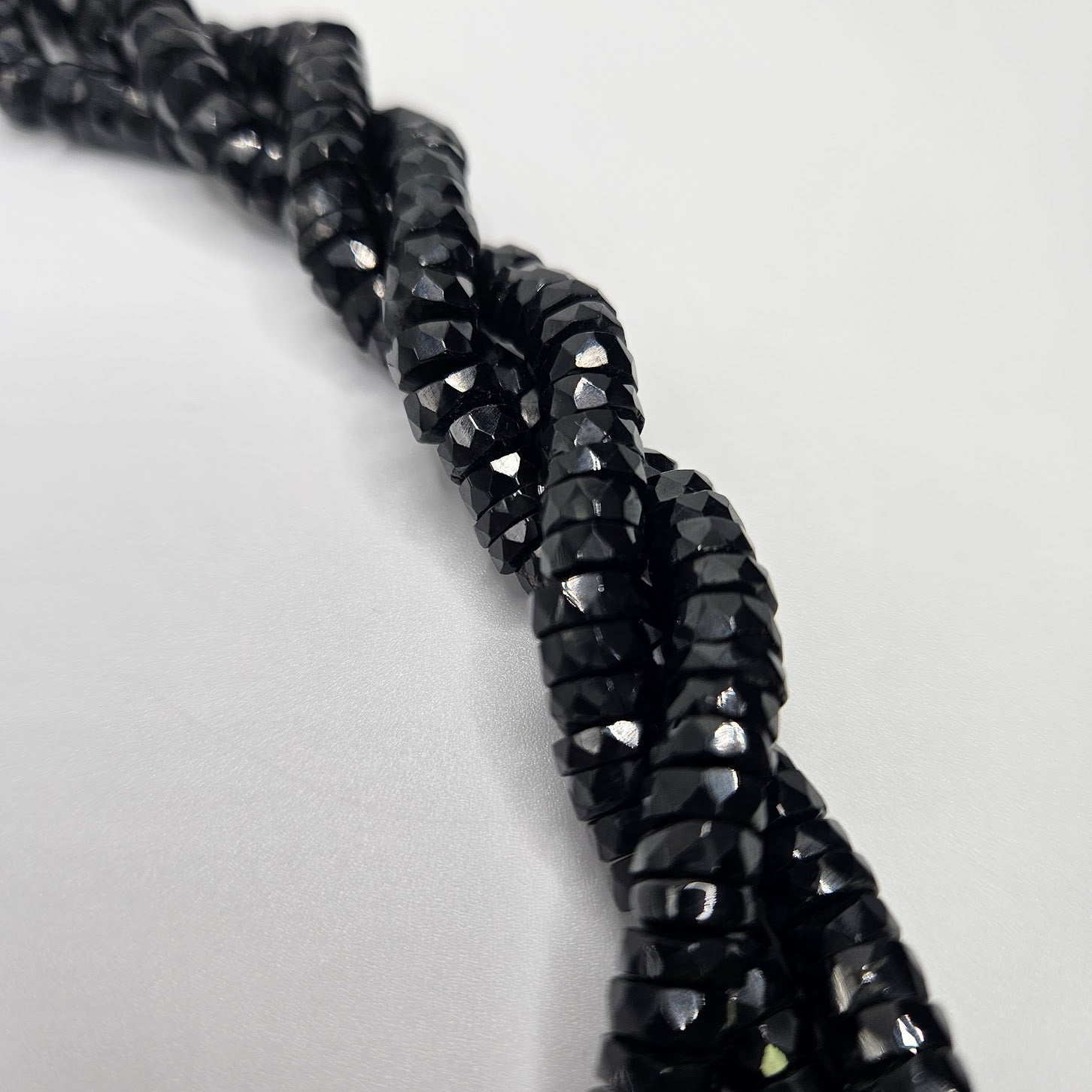 6mm Black Spinel Faceted Coin Strand.