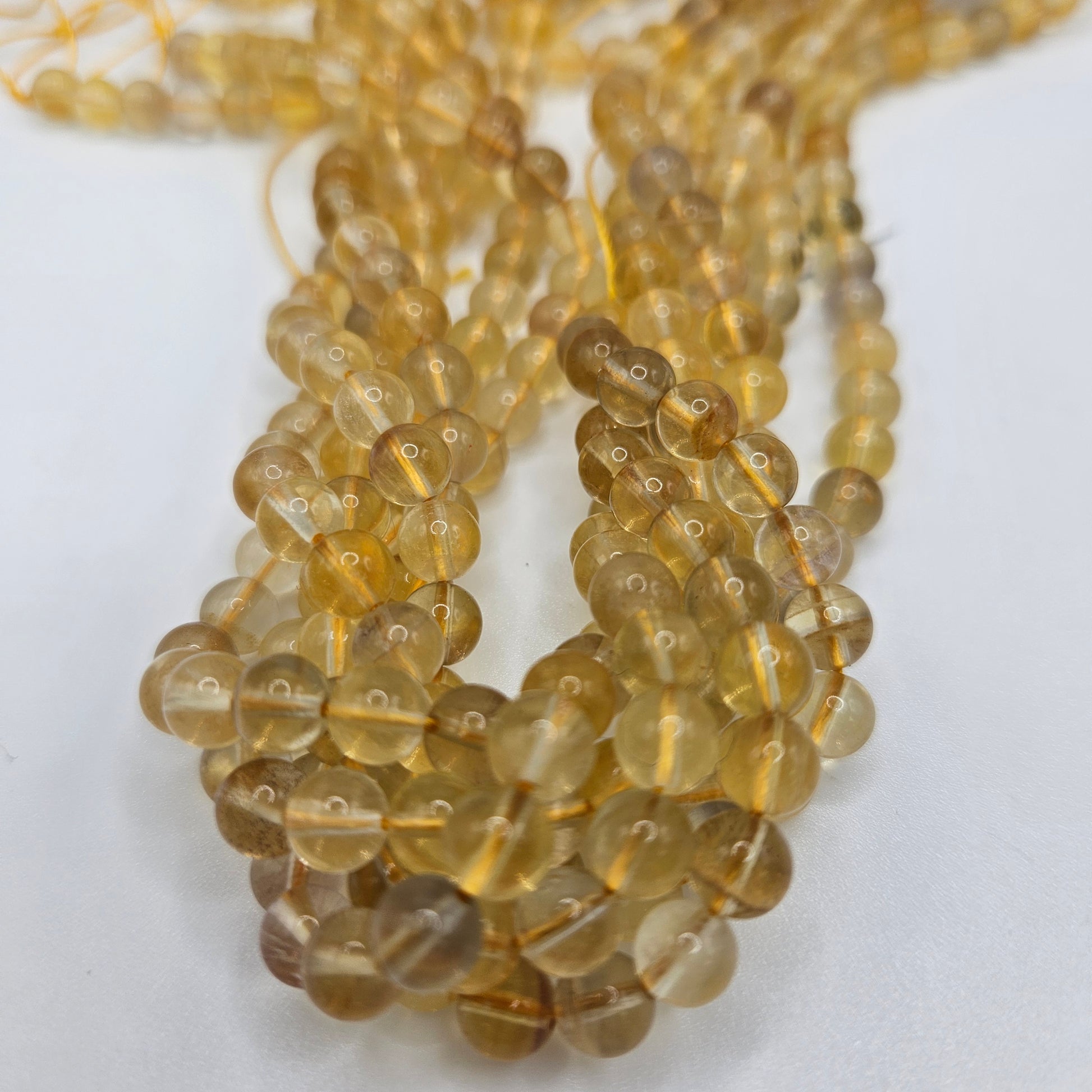6mm Yellow Fluorite Round Bead Strand.