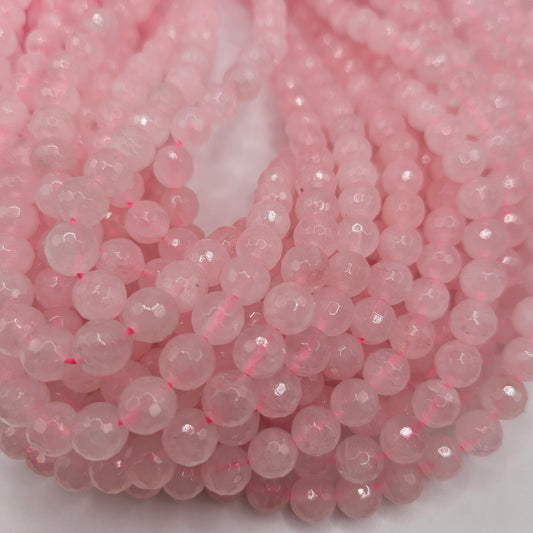 A close-up image features the 8mm Rose Quartz Faceted Bead Strand, with several strands arranged in a loose coil pattern. The faceted beads reflect light, creating a soft, sparkling effect against the white background that enhances their pastel color.