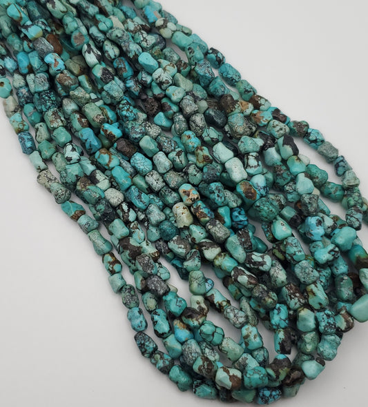 8x10mm Turquoise Dog Bone Bead Strand.