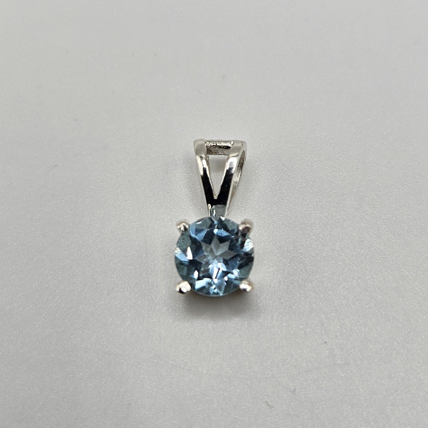 Blue Topaz Sterling Silver Round Faceted Pendant.