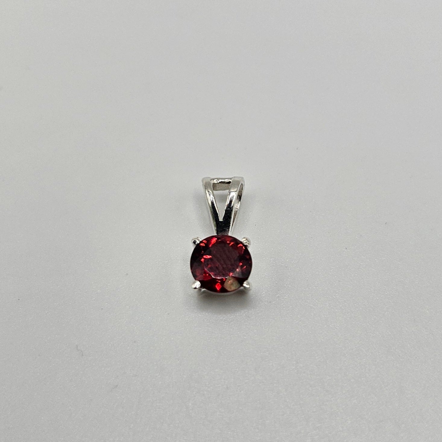 Garnet Sterling Silver Round Faceted Pendant.