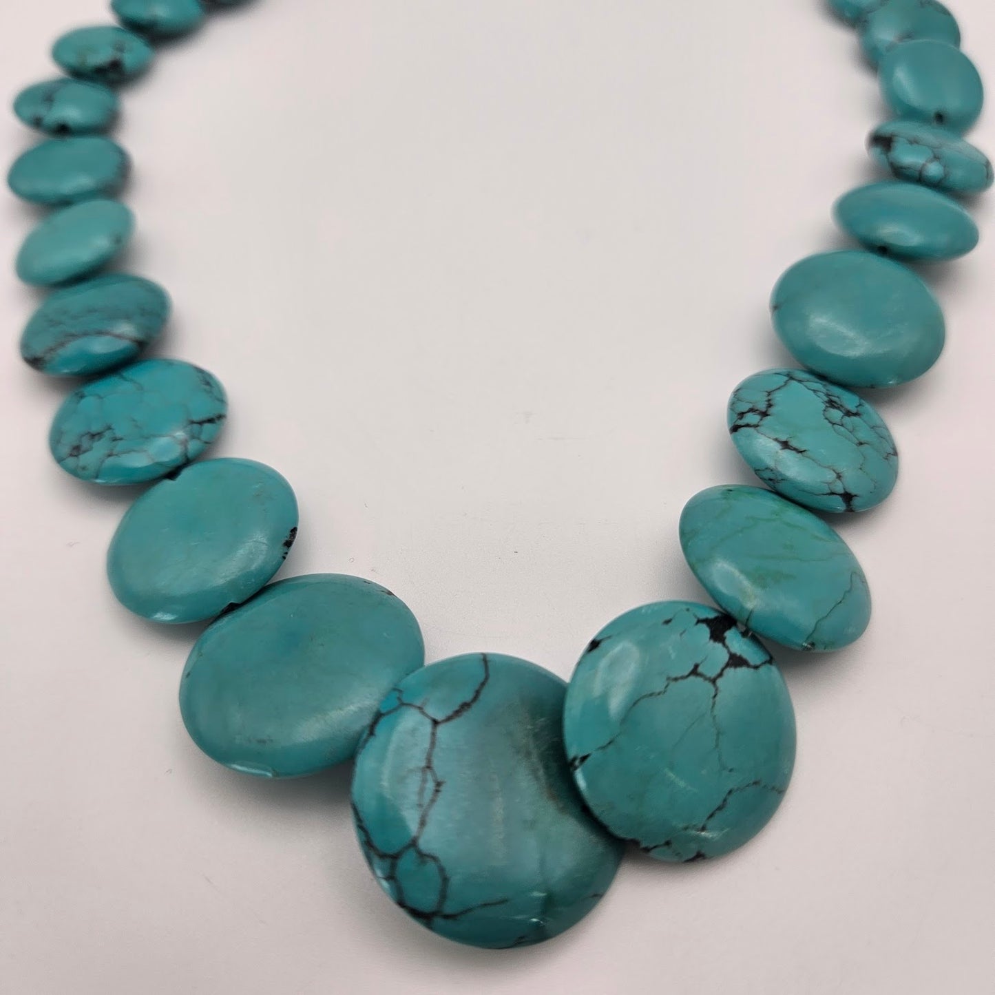 Graduated Turquoise Circle Bead.