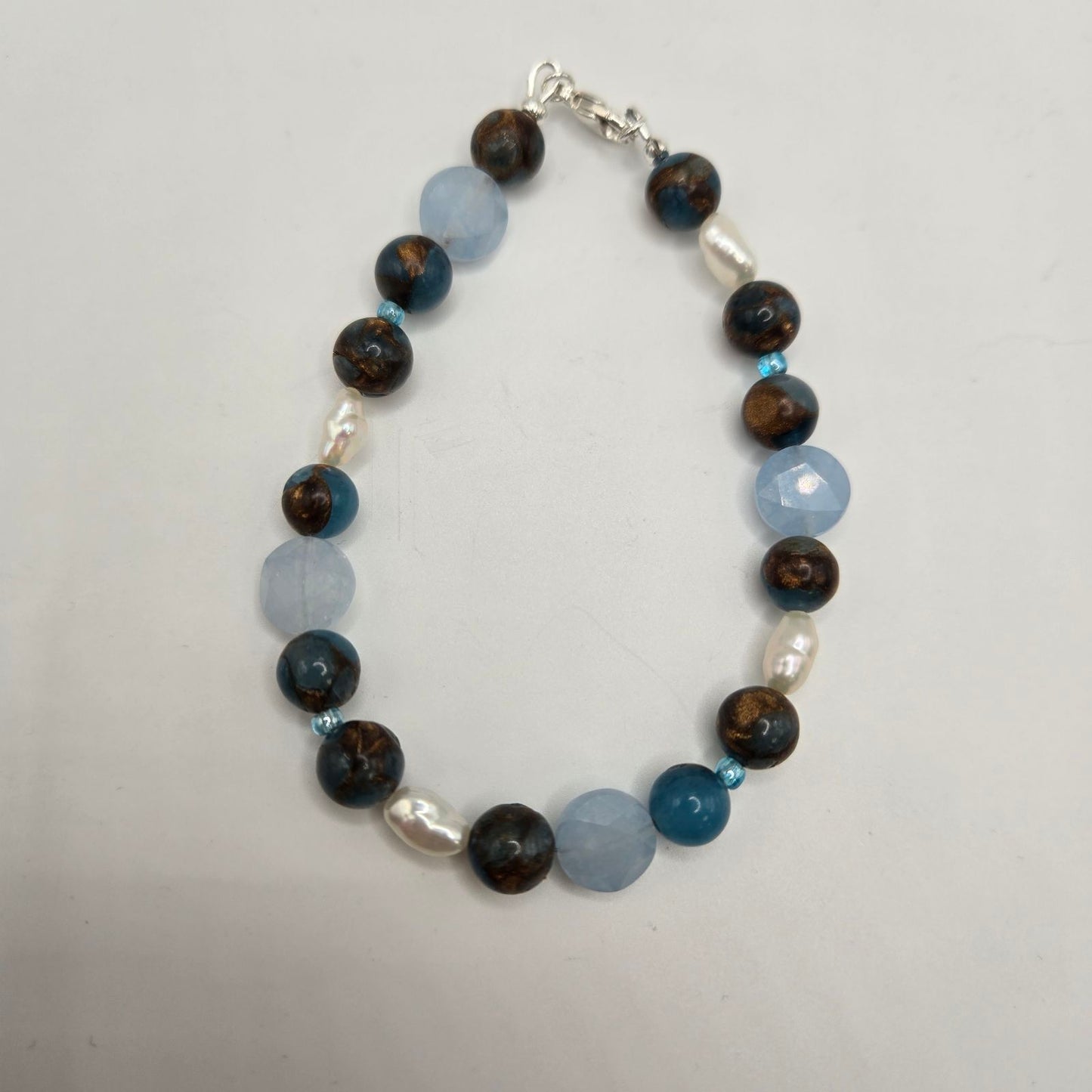 A bracelet with a mix of dark and light brown jasper beads,