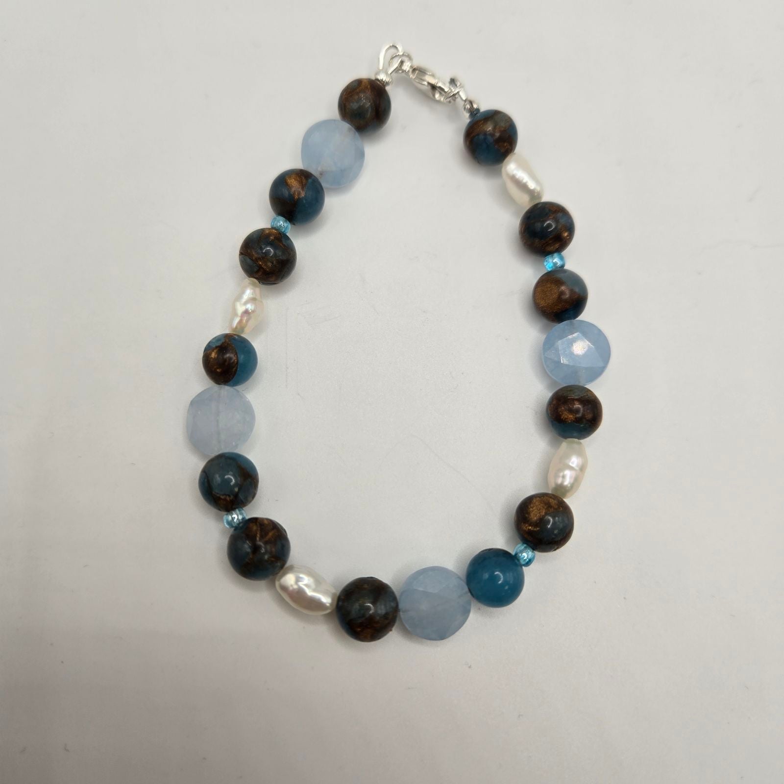 A bracelet with a mix of dark and light brown jasper beads,
