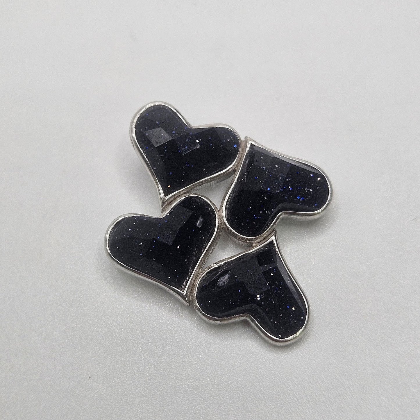 Purple Goldstone four heart pendant.