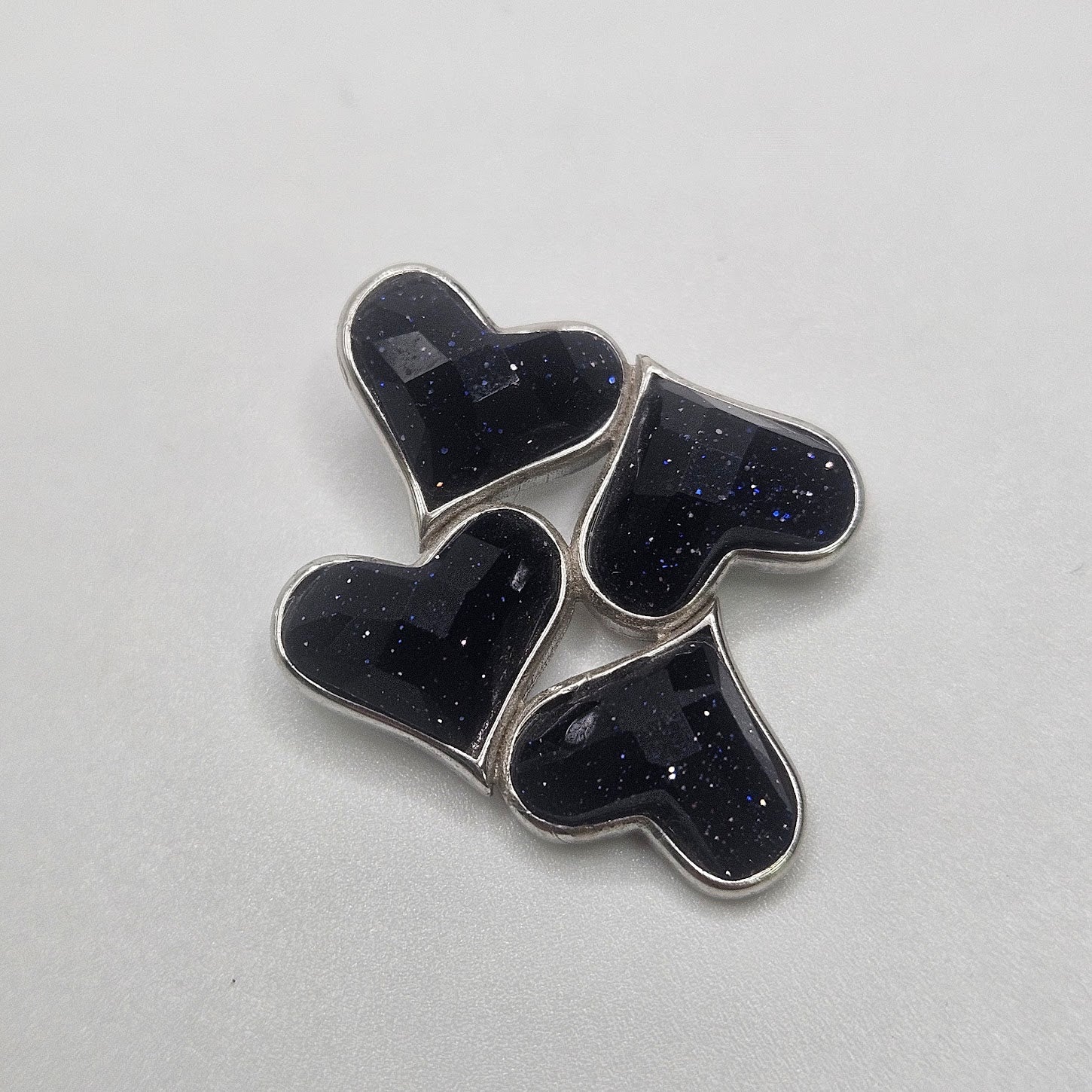 Purple Goldstone four heart pendant.