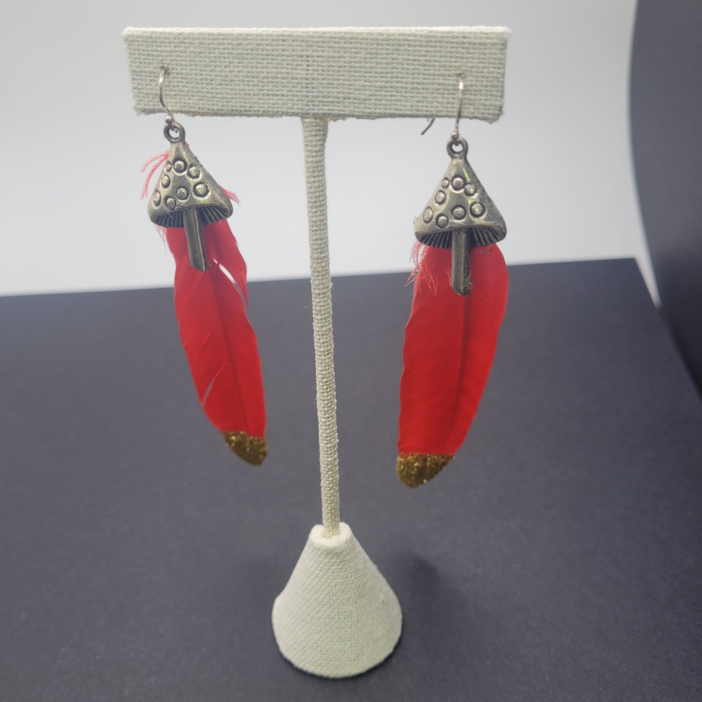 Red and Gold Feather Earrings With Mushroom Charm.