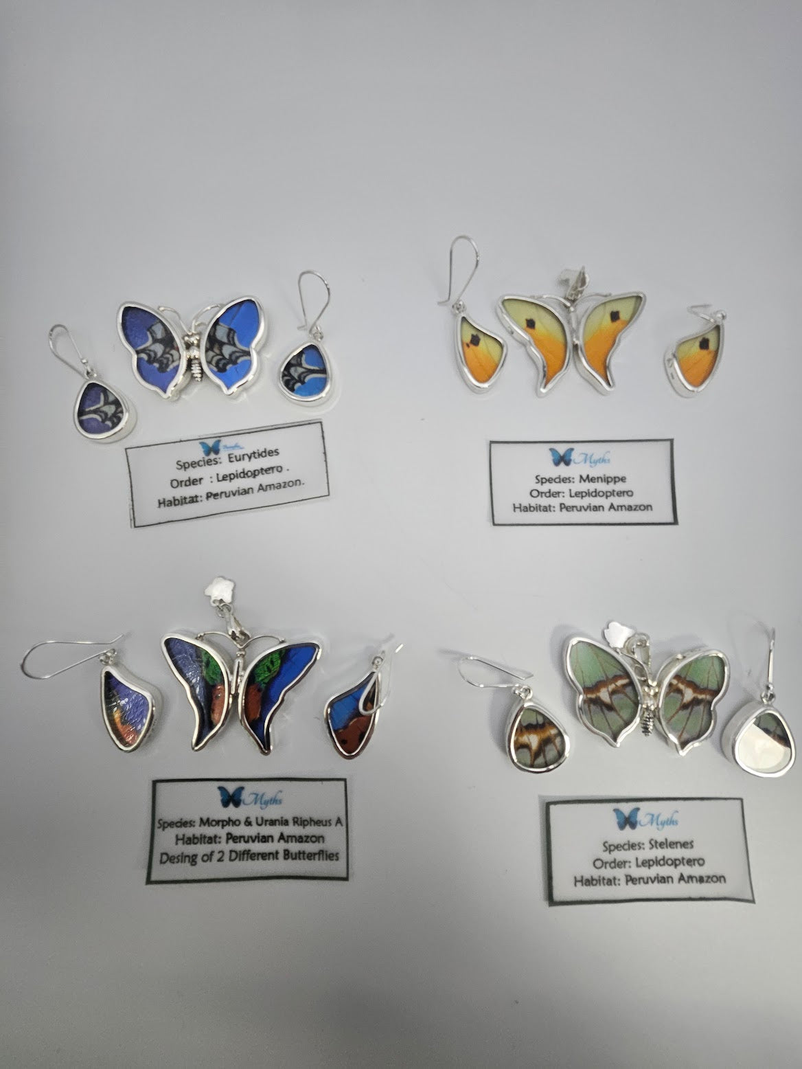 Explore the captivating Sterling Silver Butterfly Small Set, artfully designed to resemble butterflies and leaves. Each item in this collection boasts distinct colors and patterns, complete with labels showcasing butterfly species, order (Lepidoptera), habitat (Peruvian Amazon), and inspirations derived from a butterfly sanctuary.