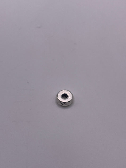 A Pewter Nut Single Bead .45 rests on a smooth, light gray surface.