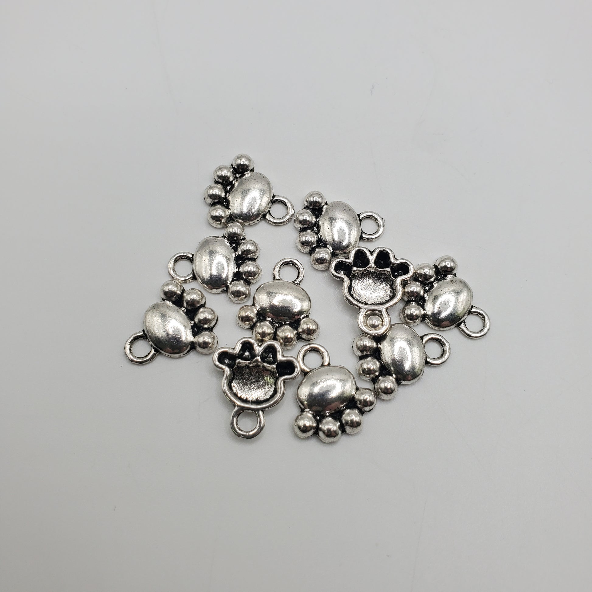 Pewter paw charm.