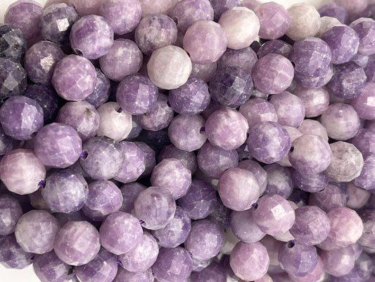 A close-up view of multiple 8mm Faceted Lepidolite Round gemstone beads. The beads showcase various shades of purple, ranging from light lavender to deep purple, and are strung closely together, highlighting their shiny and polished surfaces.
